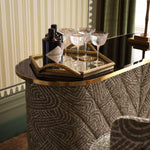 Close-up of Bar Matthew highlighting Brass, Glass, Viscose, Linen, Polyester, Acrylic and Brushed Brass, Black Glass, Camari Green (Image 10)