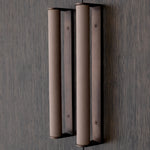 Eichholtz Bar Cabinet Harrison hanging racks that together can accommodate up to 16 wine or cocktail glasses. Medium bronze