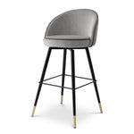 Eichholtz Bar Stool Cooper set of 2 into the realms of luxury. Enveloped in opulent Roche Light Grey Velvet with roche dark