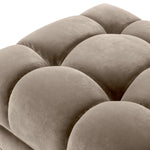 Eichholtz Bench Sienna in a tufted upholstery in mellow Savona greige velvet. Black finished legs add extra glamour