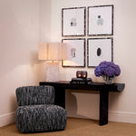 Eichholtz Chair Leon artisan craftsmanship, showcases BouclÃ© Sonata black fabric accented by a brushed brass detail on the