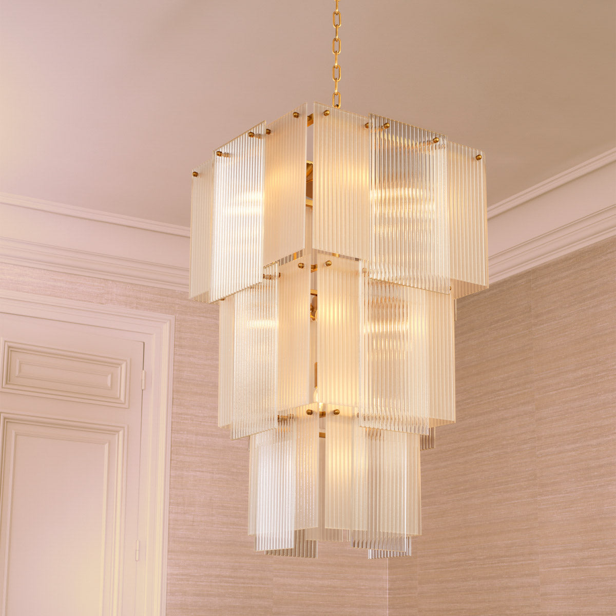 Eichholtz Chandelier Giardano panels emanate an enchanting glow, all anchored by an antique brass finish that exudes timeless