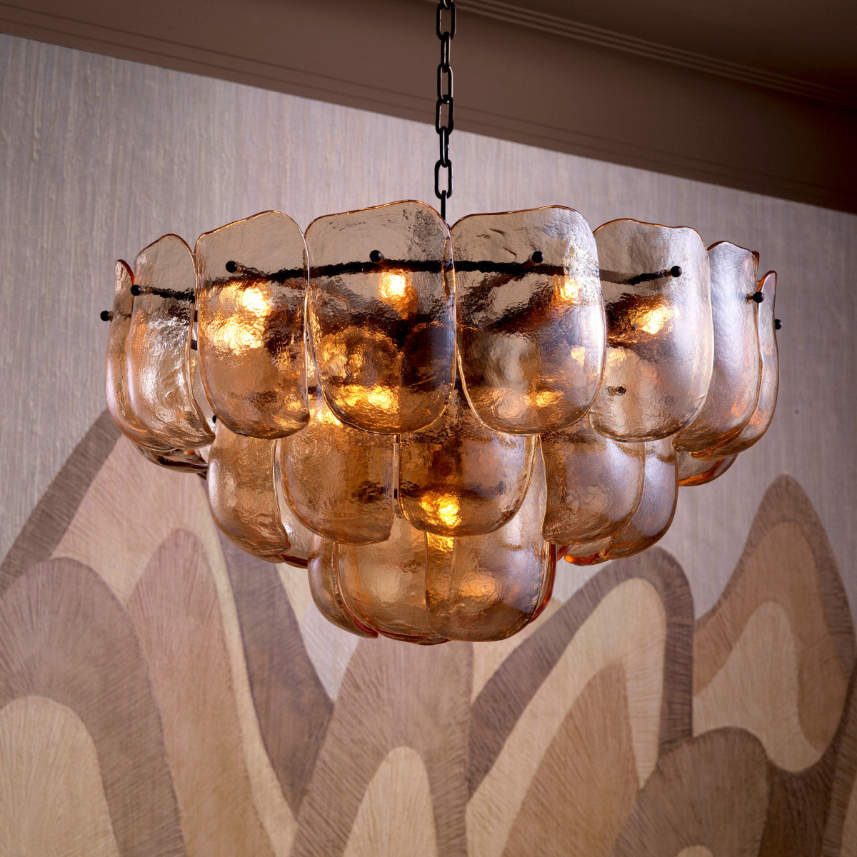 Eichholtz Chandelier Gustave bold bronze finish, exuding an alluring glow. Thick glass design brings a touch of grandeur,