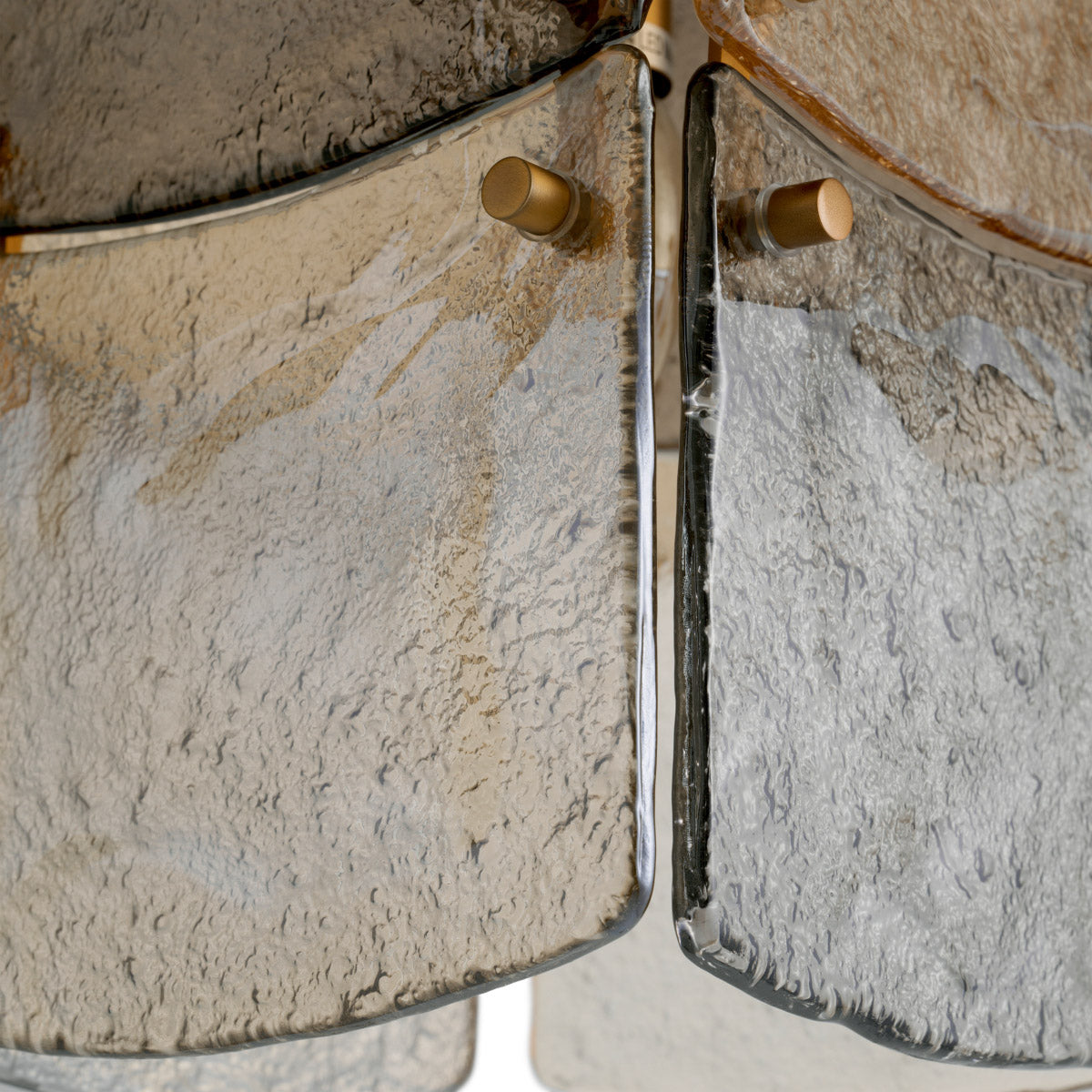 Eichholtz Chandelier Laurent of delicate smoke, light smoke, and champagne glass. The antique brass finish enhances its sophisticated