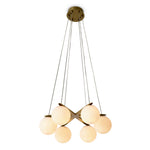 Eichholtz Chandelier Morro in lighting. Gracefully suspended, five alabaster balls glow warmly beneath an antique brass finish, providing