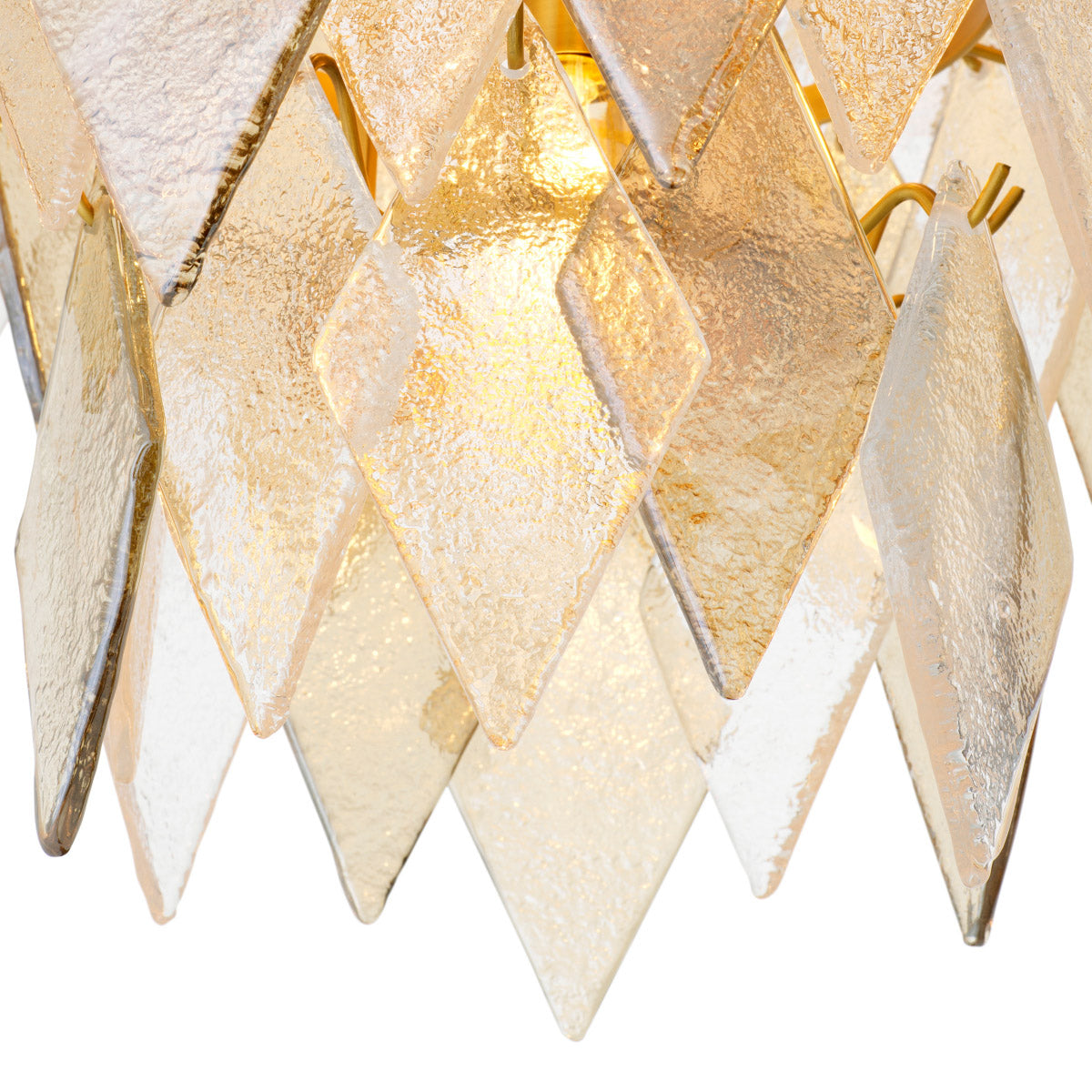 Eichholtz Chandelier Rhombus L where handmade sugared glass meets an antique brass finish. This luxurious centerpiece captivates with its