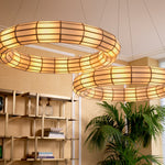 Eichholtz Chandelier Ronco ceiling lamp's distinct antique brass finish and handmade glass panels cast a serene ambiance in