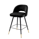 Eichholtz Counter Stool Cliff in a set of 2. Featuring black tapered legs with gold caps, the solid frame