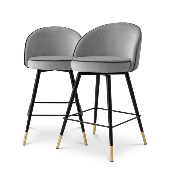 Eichholtz Counter Stool Cooper set of 2 The Counter Stool Cooper is an exquisite set of 2 that epitomizes timeless elegance. Draped