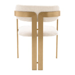 Eichholtz Dining Chair Donato the rounded backrest. The frame features a brushed brass finish and is upholstered in our