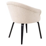 Eichholtz Dining Chair Moretti with a black finish. The soft touch BouclÃ© cream upholstery is inviting and matches with