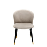 Eichholtz Dining Chair Volante curved back is designed to cocoon around you. Tapered black legs with brass tips detailing