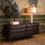 Eichholtz Drawer Dresser Denver veneer meets the alluring elegance of brushed brass finish legs, showcasing a harmonious blend of