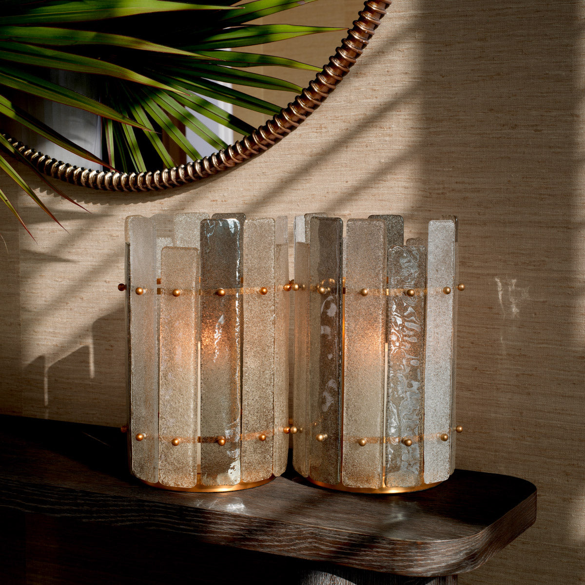 Eichholtz Hurricane Greyson features a vintage brass finish and a hand-blown glass shade in a captivating grey hue.