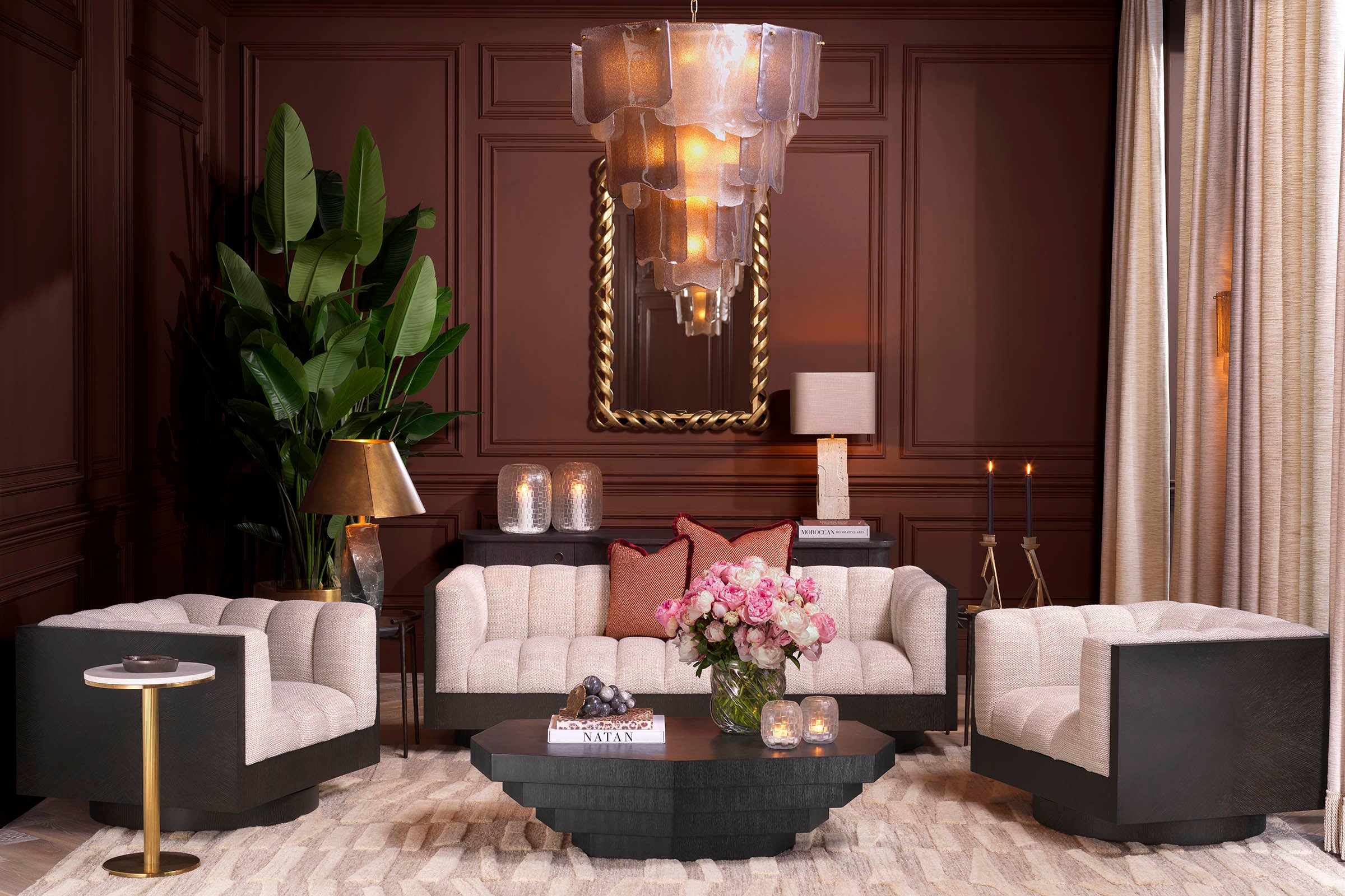 Console table with ornate mirror in a dramatic dark-panelled room