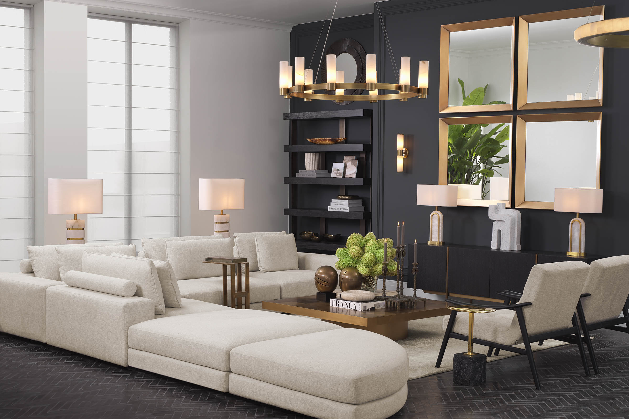 A curated Eichholtz interior with a dark accent wall, cream sectional, and layered console and mirror grouping.
