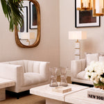 Eichholtz Mirror Casimir with an antique gold finish. The outside of the frame is rectangular with rounded corners,