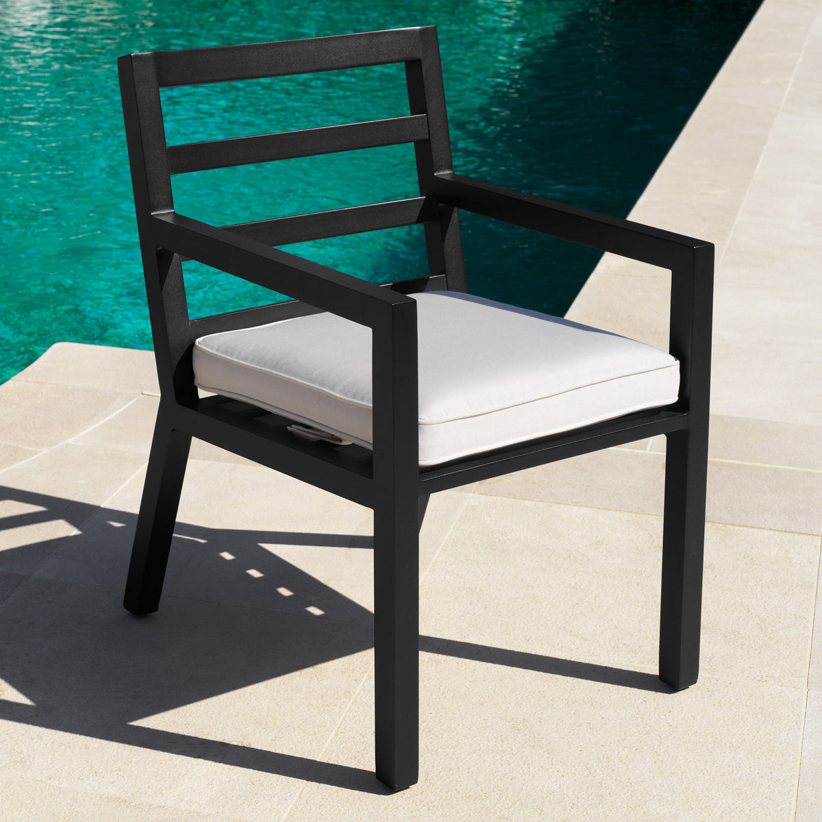 Eichholtz Outdoor Dining Chair Delta complement Dining Table Vistamar, this black finish dining chair with arms features a sleek silhouette.