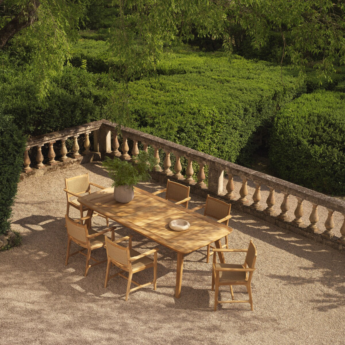 Eichholtz Outdoor Dining Chair Pivetti with arm celebrates nature's beauty. Crafted from sustainably sourced Grade A teak wood, the chair...