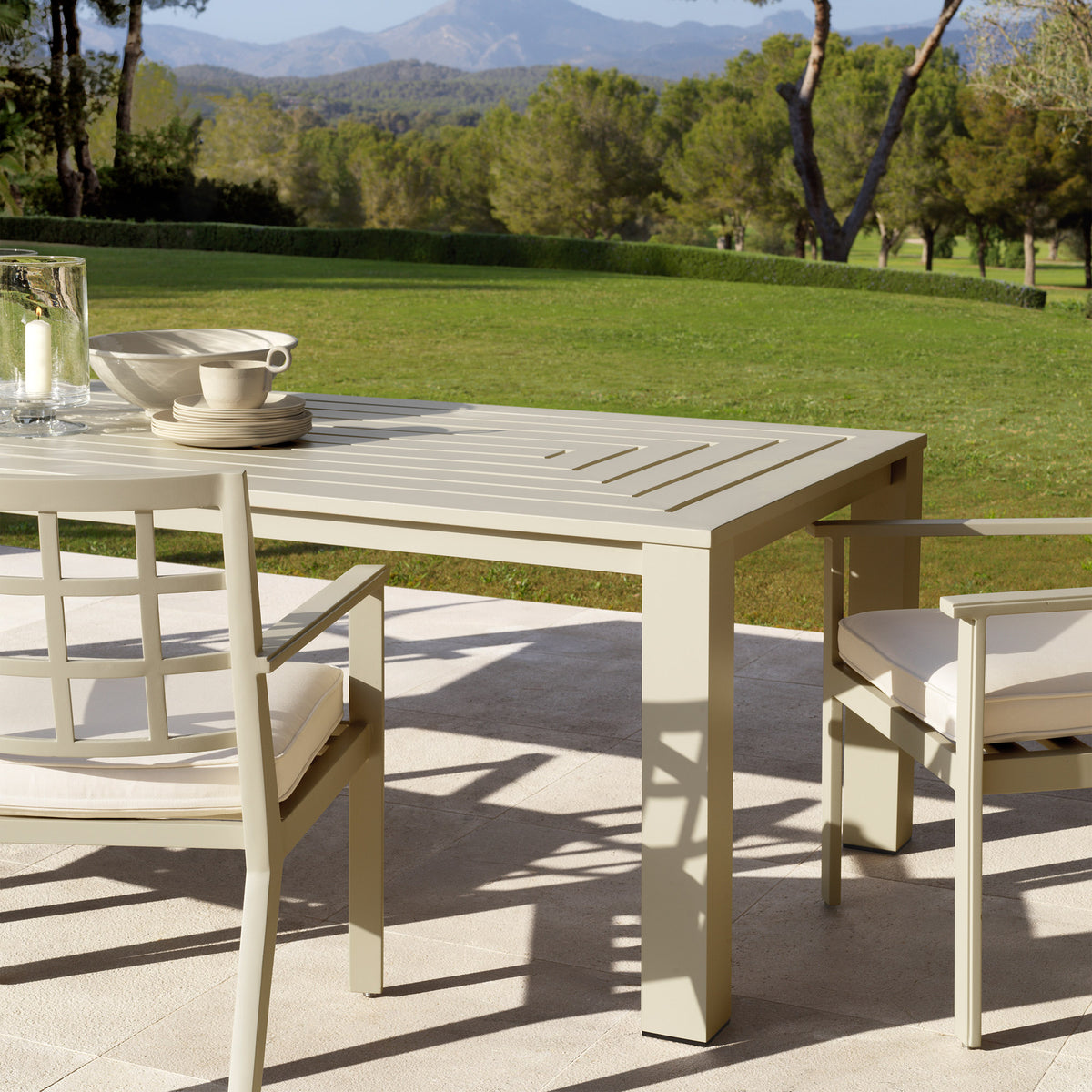 Eichholtz Outdoor Dining Table Vistamar for long-term outdoor use, this luxurious sand finish dining table with decorative slits will add