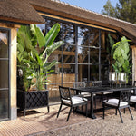 Eichholtz Outdoor Planter Ocean Club area. Filled with a multitude of plants or flowers, this elegant matte black planter box