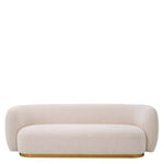 Eichholtz Sofa Roxy on a brushed brass base, this accent chair features a sheltering arc from arm to