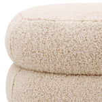 Eichholtz Stool Tulum by its unique marshmallow-like curves in Brisbane cream upholstery. Black feet round out the captivating