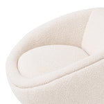 Eichholtz Swivel Chair Bollinger wrapped in a soft-touch BouclÃ© cream fabric and mounted on a brushed brass swivel base.