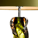 Eichholtz Table Lamp Carnegie a lively effect. Its elegant shape and fascinating texture is amplified by a round olive