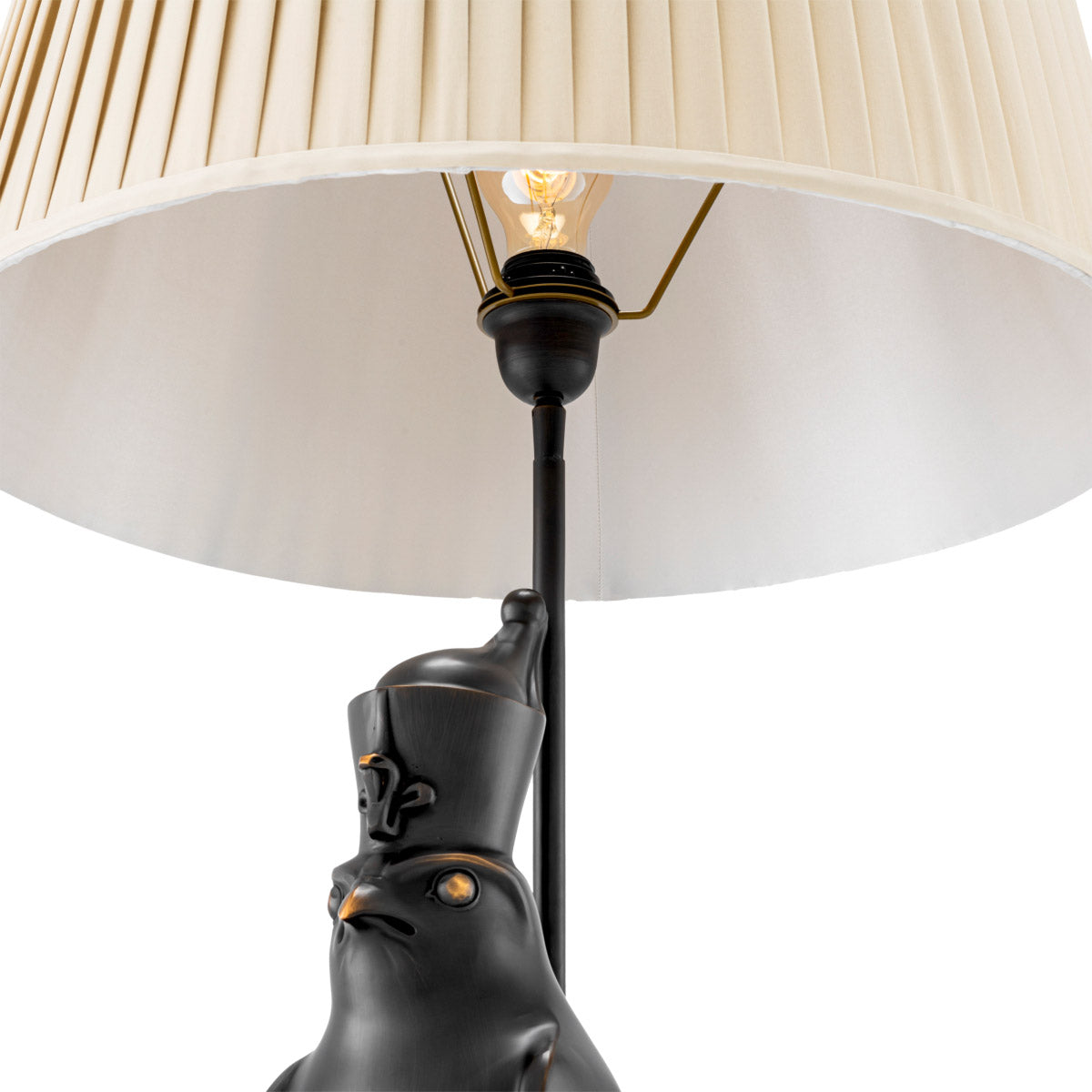 Eichholtz Table lamp Horus to as "Nectanebo-the-Falcon." This regal lamp, which boasts a copper-bronze finish and a beige pleated