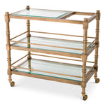 Eichholtz Trolley Alexia Provided with a vintage brass finish and shelevs of bevelled clear glass, Trolley Alexia will