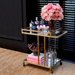 Eichholtz Trolley Beverly Hills stainless steel frame with a brushed brass finish and two shelves of bevelled mirror glass,