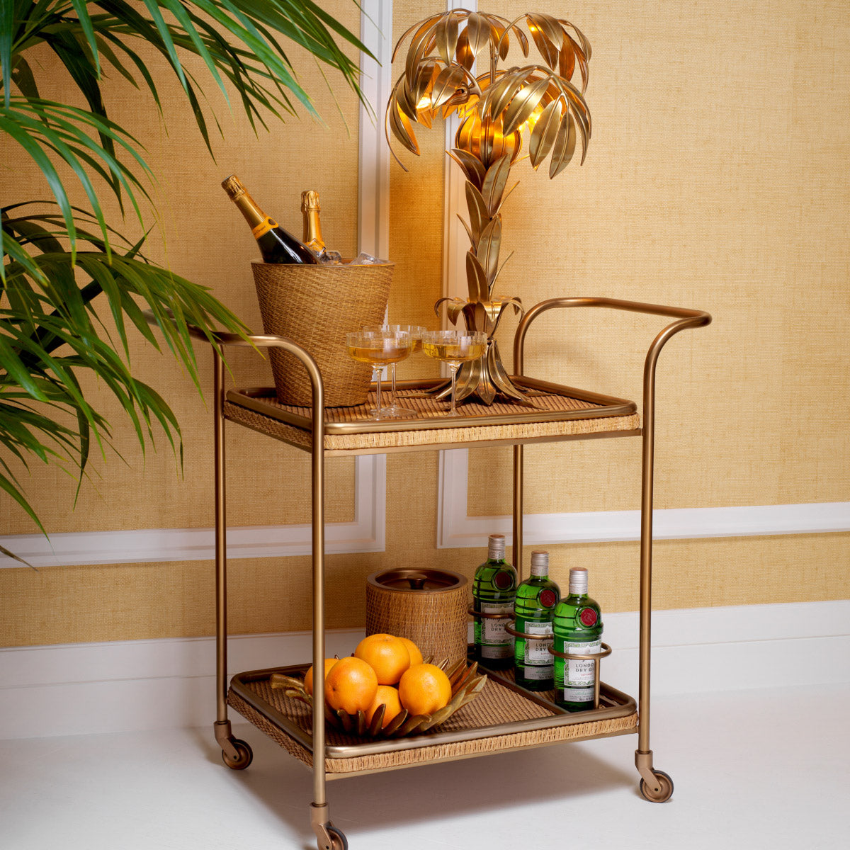Eichholtz Trolley Pescara rattan tiers. This chic bar cart comes ready with four bar accessories, blending form and