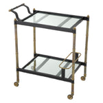 Eichholtz Trolley Princess beveled glass shelves add a touch of sophistication, while the wheels provide effortless mobility. Whether